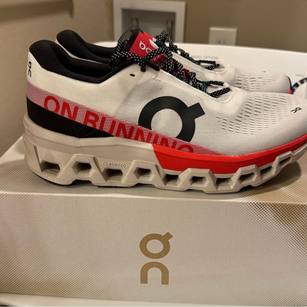 On Running White and Red Athletic Shoes